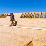 Home roof construction applying roof plywood panels in new house Home roof construction applying roof plywood panels in new house