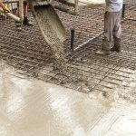 Pouring concrete into the construction of the house. Builders are pouring ready-mixed concrete Pouring concrete into the construction of the house. Builders are pouring ready-mixed concrete